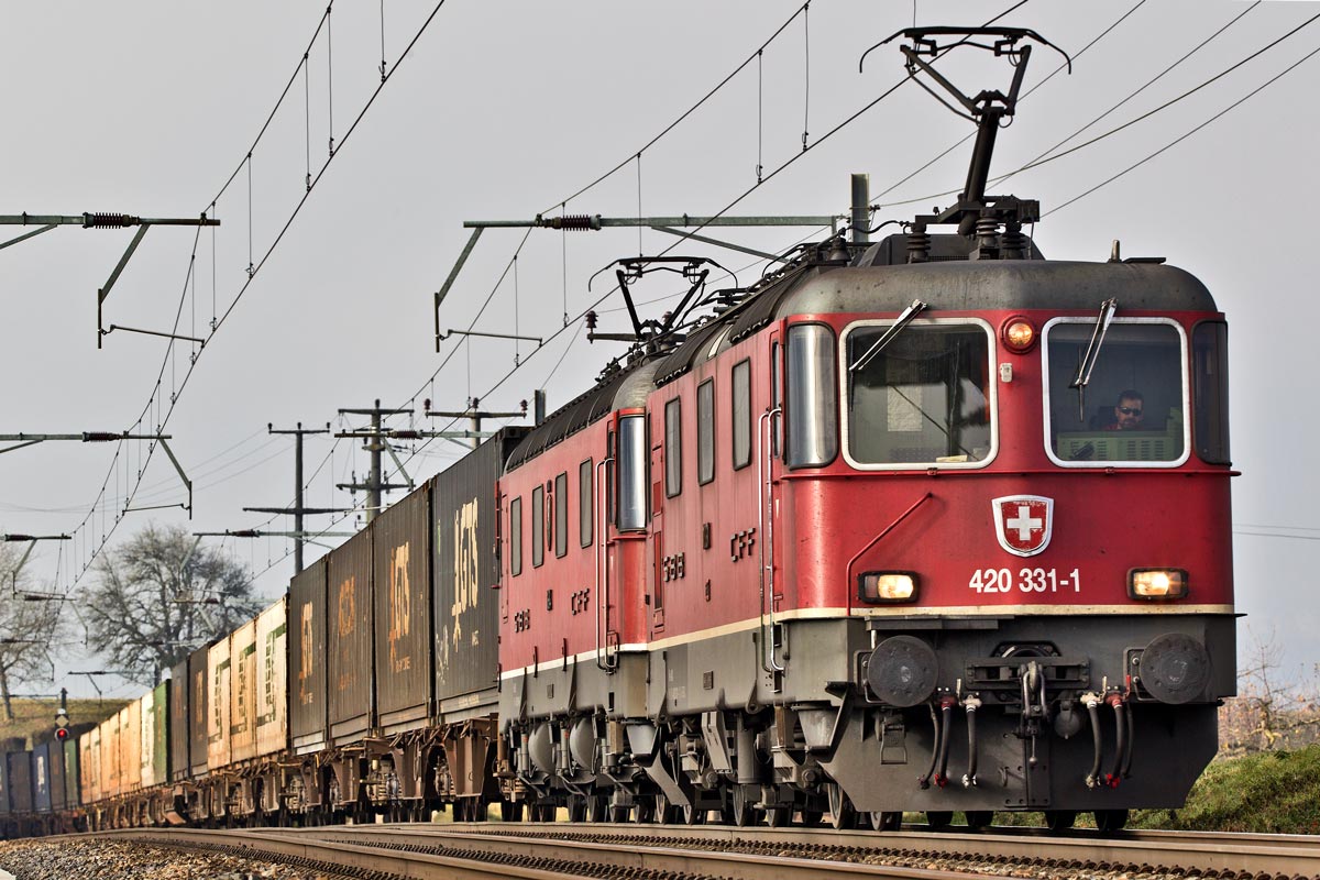 In Front einer Re 10/10 fährt die 420 331-1 mit einem Containerzug in Möhlin vorüber.Bild vom 7.12.2016