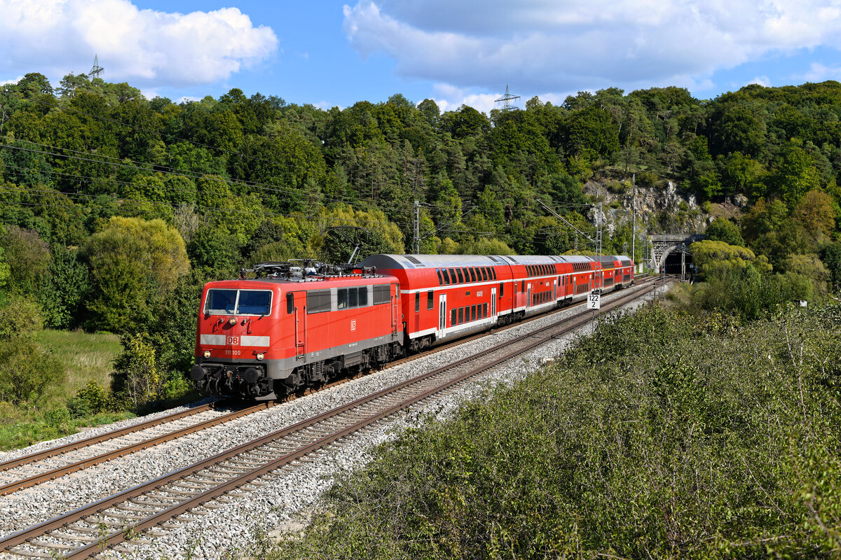 Jahrzehntelang in Frankfurt am Main beheimatet verstärkt die 111 100 nun seit Ende 2021 den Münchner Bestand der Baureihe. Am 21. September 2022 bespannte sie die RB 59154 nach Nürnberg HBF. Der Zug verkehrte anstelle des planmäßigen Triebzug der Baureihe 445. Entstanden ist die Aufnahme bei Esslingen im Altmühltal, kurz nach Verlassen des gleichnamigen Tunnels.