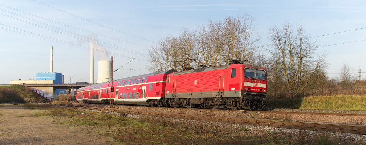 Kurvenlage - 143 825 bringt den RE aus Koblenz in Richtung Saarbrücken. Hier bei Bous setzt die Herbstsonne den Zug ins warme Licht, im Hintergrund das Kraftwerk in Ensdorf. Bahnstrecke 3230 Saarbrücken - Karthaus am 23.11.2014

