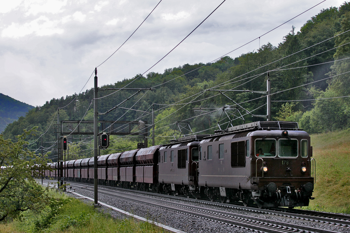 Kurz nach einem sehr heftigen Hagelgewitter fährt die Doppeltraktion der beiden BLS Loks Re 425
178  Schwarzenberg  und Re 425 174  Frutigen  mit einem Kohlenzug in Villnachern den Bözberg hinab.Bild vom 15.6.2016