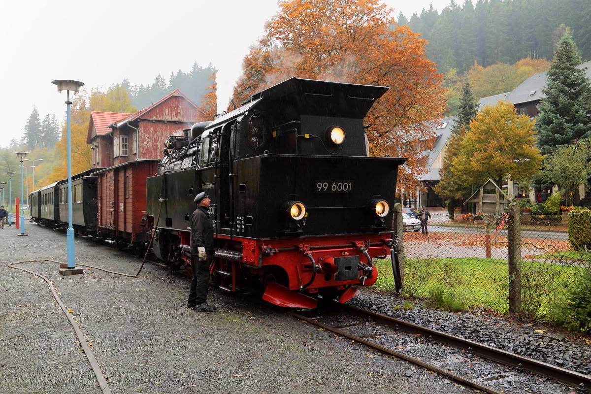Letztes Wasserfassen. Per C-Schlauch ergänzt 99 6001, am 22.10.2016 unterwegs mit einem Sonderzug der IG HSB, im Bahnhof Alexisbad nochmals ihre Wasservorräte. Nachdem dann Triebwagen P8973 (Quedlinburg-Hasselfelde) eingefahren ist, wird die Fahrt dann zügig zum Endpunkt der heutigen Reise, Quedlinburg, fortgesetzt.