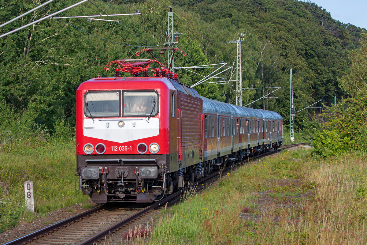 Lok 112 035 mit dem „Strand Express“ auf der Rückfahrt von Binz nach Potzdam hier auf Rügen. - 06.08.2022
