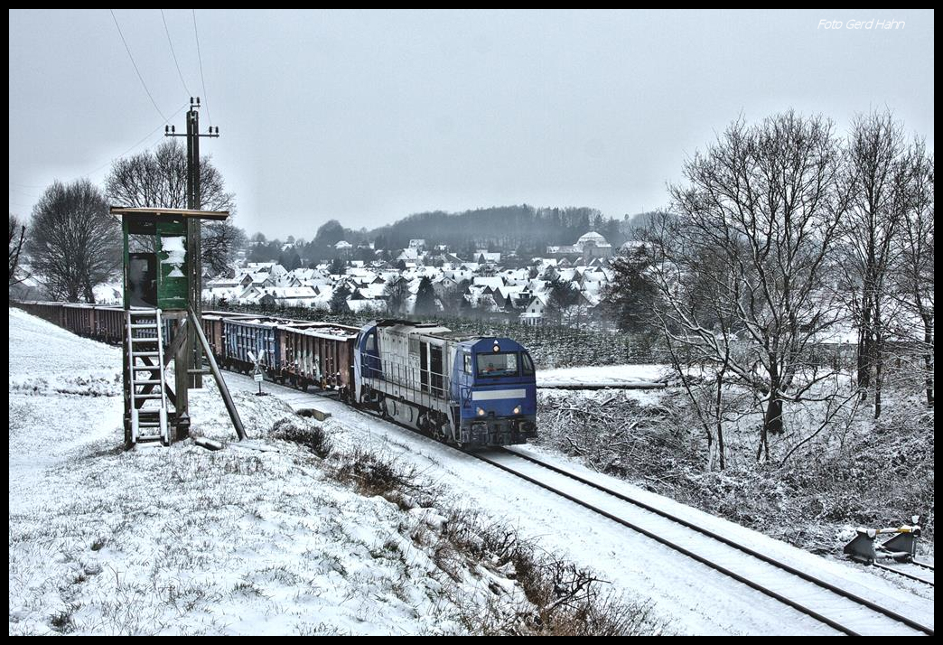 Lok G 2000 mit der Nummer 273004-2 ATLU erreicht hier am 7.2.2017 mit einem Schrottzug um 11.43 Uhr Georgsmarienhütte. Im Hintergrund ist der Ortsteil Holzhausen mit der Klosterkirche Ohrbeck zu sehen.