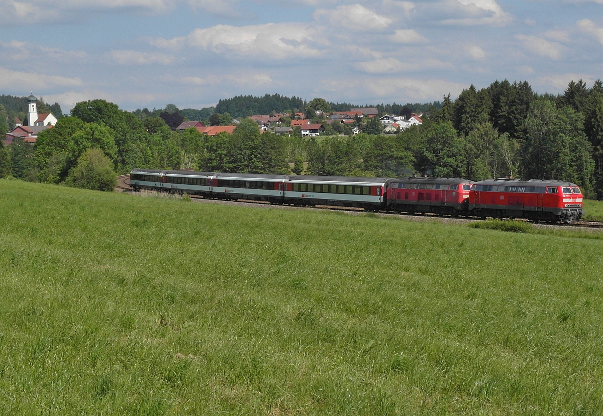 Mit Blick auf die Kirche und Huser von Maria-Thann befindet sich EC 1290, Mnchen-Zrich am 15.06.2014 auf der Fahrt nach Lindau.