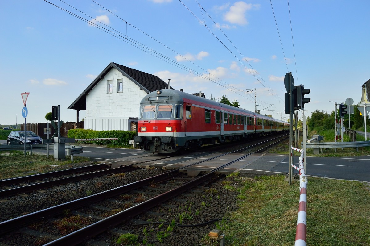 Mit dem Karlsruhersteuerwagen vorne weg, schiebt die 111 112 einen Verstärkerzug der RE4 nach Aachen Hbf. Hier ist der Zug am Bü Dahler Weg in Wickrath zu sehen. 16.5.2014