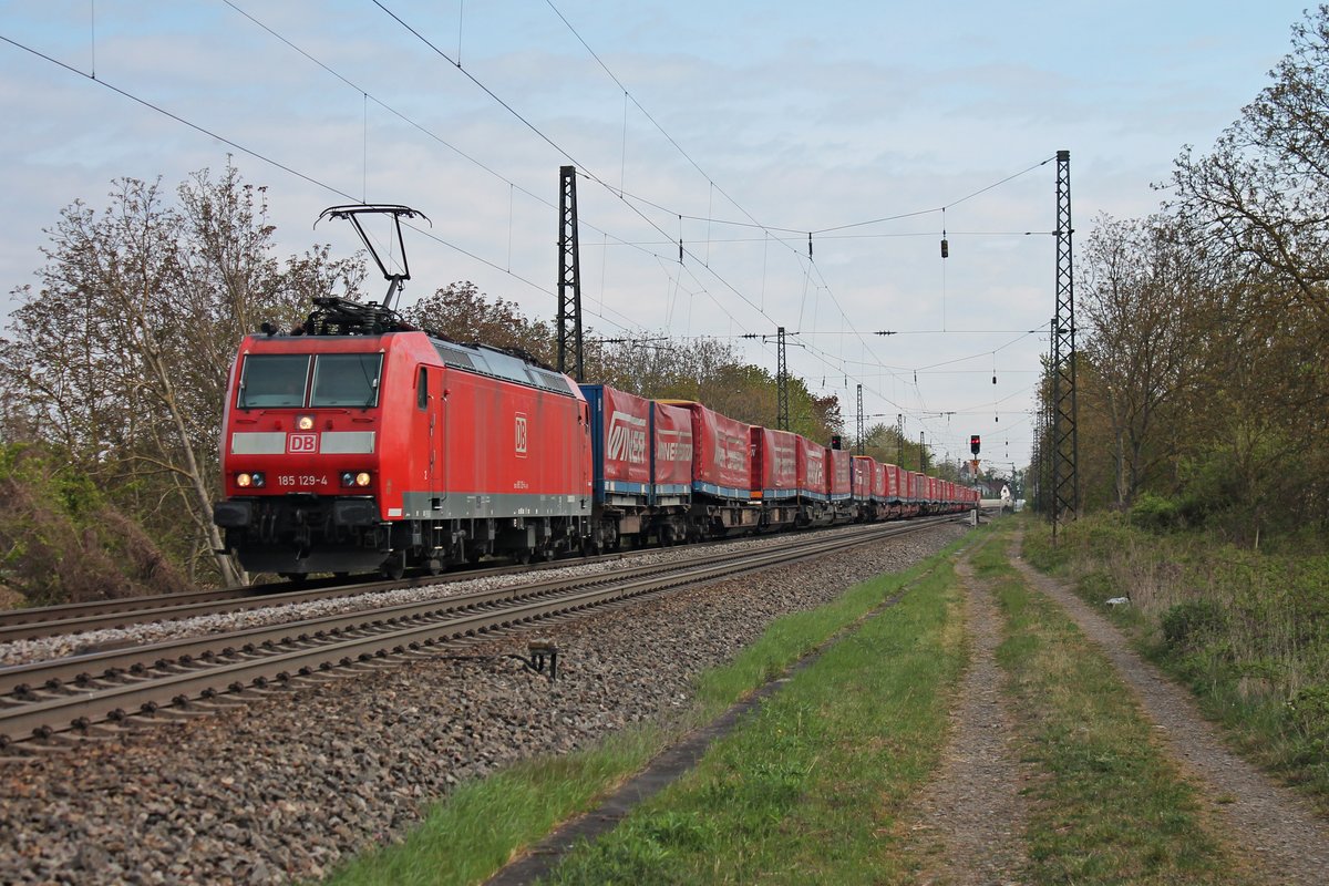 Mit dem  Winner -KLV aus Wuppertal fuhr am 13.04.2017 die 185 129-4 über die KBS 703 durch Heitersheim in Richtung Schweizer Grenze.