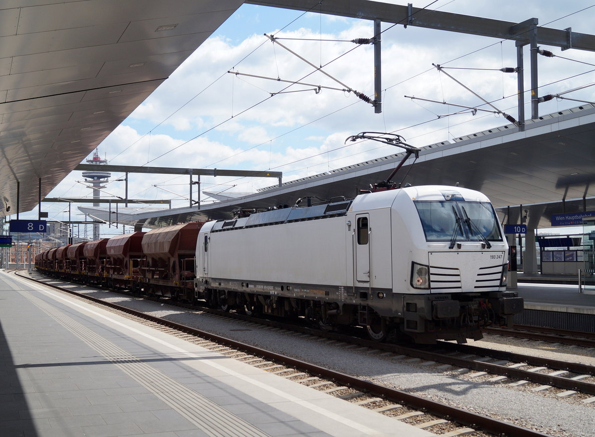 Mit einem aus Richtung Osten kommenden Güterzug durchfährt die weiße 193 247 am 28. April 2019 den Wiener Hauptbahnhof.