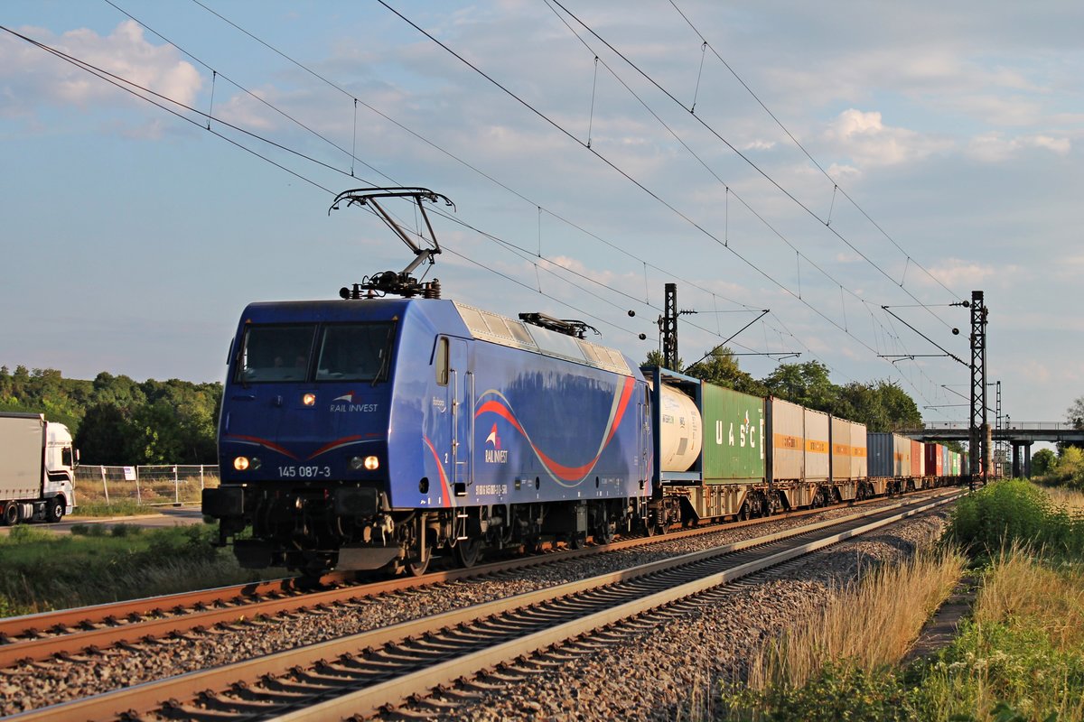 Mit einem Containerzug aus Weil am Rhein fuhr am 20.07.2017 die SRI/LTE 145 087-3 südlich von Buggingen durch die Abendsonne in Richtung Freiburg (Breisgau).