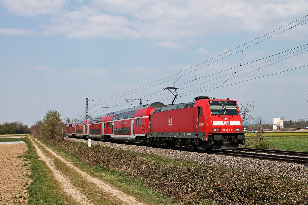 Mit einem RE (Freiburg (Brsg) Hbf - Basel Bad Bf) fuhr am Nachmittag des 09.04.2020 die 146 232-4 südlich von Buggingen über die Rheintalbahn in Richtung Müllheim (Baden), wo sie ihren nächsten Zwischenhalt einlegen wird.
