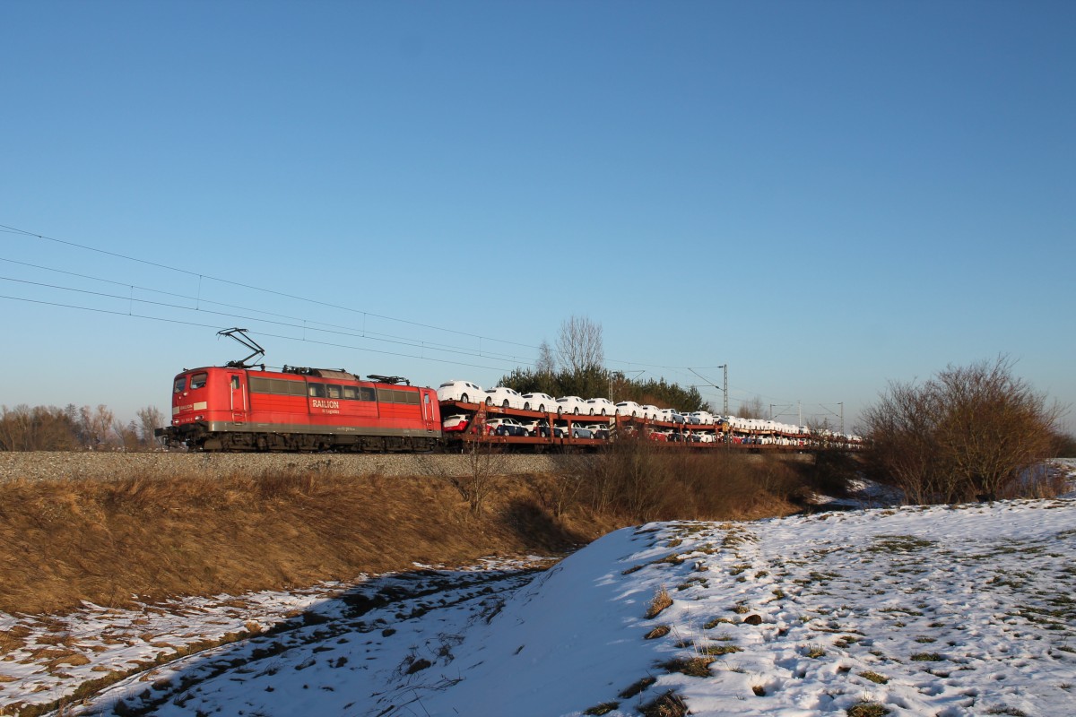 Mit ihrem schweren Autozug müht sich 151 160 an diesem sonnigen 20.02.2015 die Steigung bei Gaimersheim in Richtung Treuchtlingen ab.