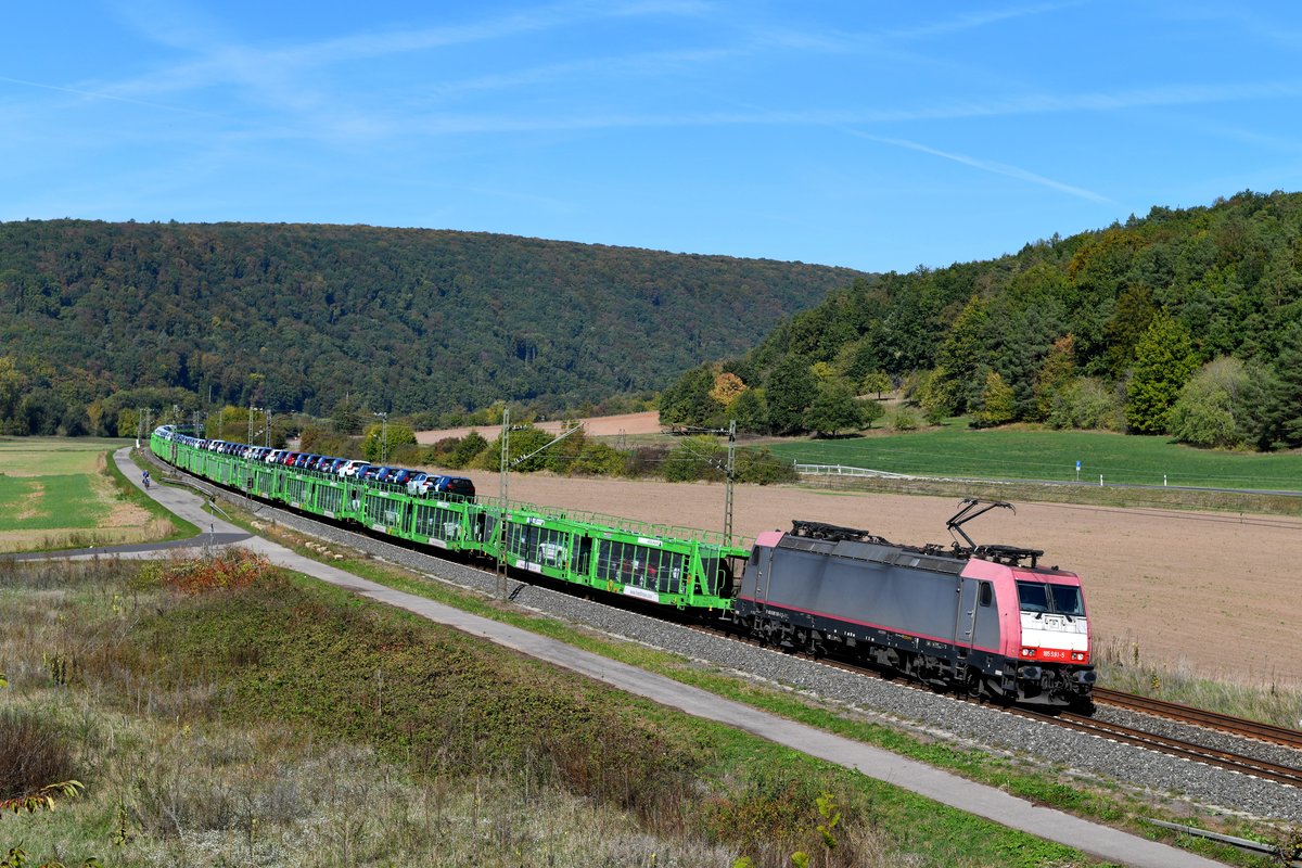 Mit einer Ladung fabrikneuer Volvos war am 05. Oktober 2018 die für die LTE fahrende 185 591 unterwegs. Die Lok zeigt noch die Farbgebung des langjährigen Einsatzes für Crossrail. Bei Harrbach im Maintal legte sich die Maschine mit ihrem aus neuen Waggons der Gattung Laaers bestehenden Ganzzug elegant in die Kurve. 