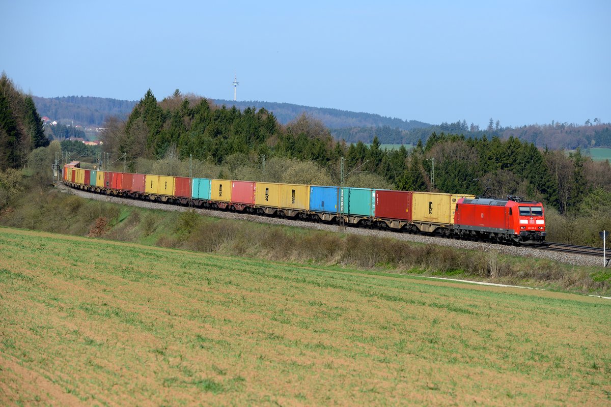 Mit seiner Ladung aus bunten Containern hebt sich der KT 50201 von Imsumer Deich nach Regensburg Ost, geführt von 185 155, gut von der noch vorfrühlingshaften Landschaft der Oberpfalz bei Darshofen ab (15. April 2015).