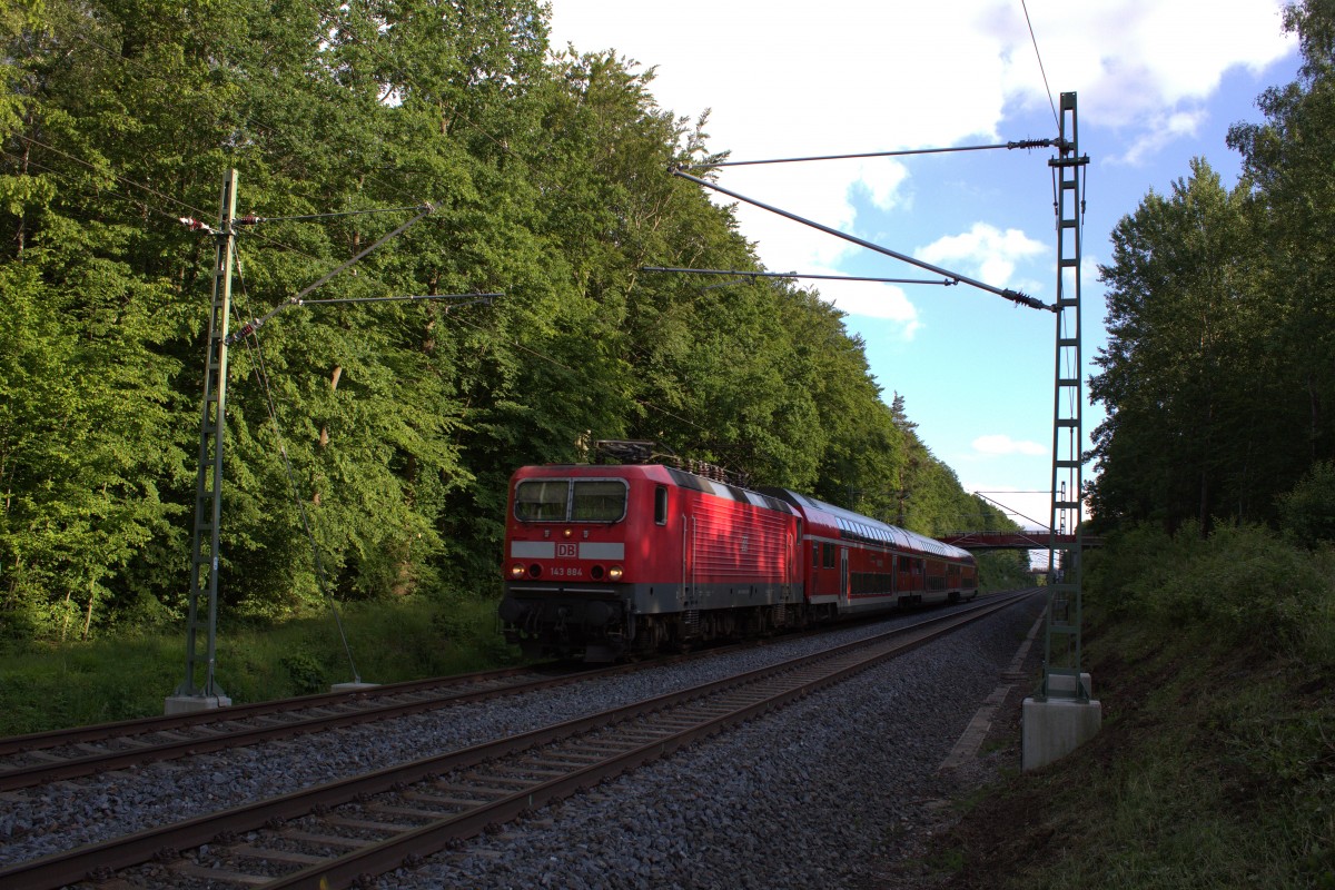 Mitten im Grünen befindet sich der RE 3 nach Dresden mit der Ziehenden 143 884. Gesehen am 24.06.2015 nahe Jößnitz. 