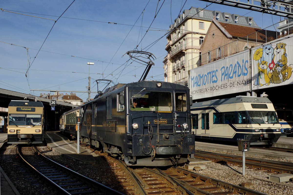 MOB/MVR/CEV: Mit der Inbetriebnahme der ABeh 2/6 7501-7508 werden die Be 2/6 7001-7004 (1997-1998) im Regionalverkehr nicht mehr gebraucht. Dank geringem Alter und gutem Zustand werden sie weiterhin im Seeland bei der ASm/BTI und im Berner Oberland bei der MIB gute Dienste leisten. Be 2/6 7003 und Be 2/6 7002 im Regionalverkehr ab Montreux am 11. Demzember 2015. Speziell zu beachten gibt es bei dieser bald historischen Aufnahme der alte und der neue Farbanstrich. 
Foto: Walter Ruetsch  