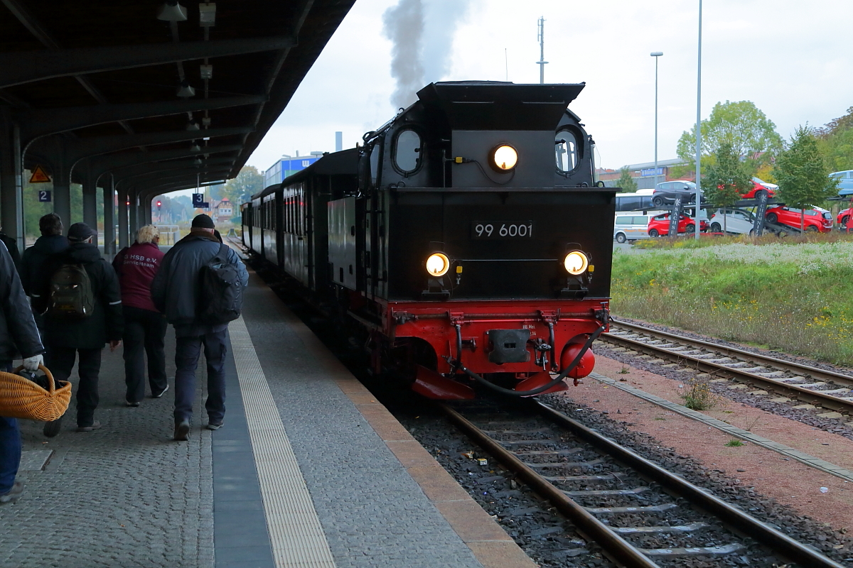 Nach erfolgtem Wasserfassen am Abend des 18.10.2015 hat 99 6001, im Bahnhof Quedlinburg, nun wieder an ihren historischen Wagenzug angekuppelt, mit welchem sie heute im Rahmen einer Sonderzugveranstaltung für die IG HSB unterwegs war. Diesen wird sie jetzt noch zurück nach Gernrode bringen, wo er zur Abstellung kommt. Hier ist für die Lok und ihr Personal, nach einem arbeitsreichen Tag, endlich Feierabend. Auf dem Bahnsteig streben derweil die letzten Fahrgäste, zu denen auch der Fotograf gehört, zu den bereitstehenden Reisebussen, welche sie zurück zum Ausgangspunkt der Fahrt, Wernigerode, bringen werden. Damit ist dann auch die dreitägige Herbstsonderzugveranstaltung der IG HSB im Jahre 2015 endgültig beendet.