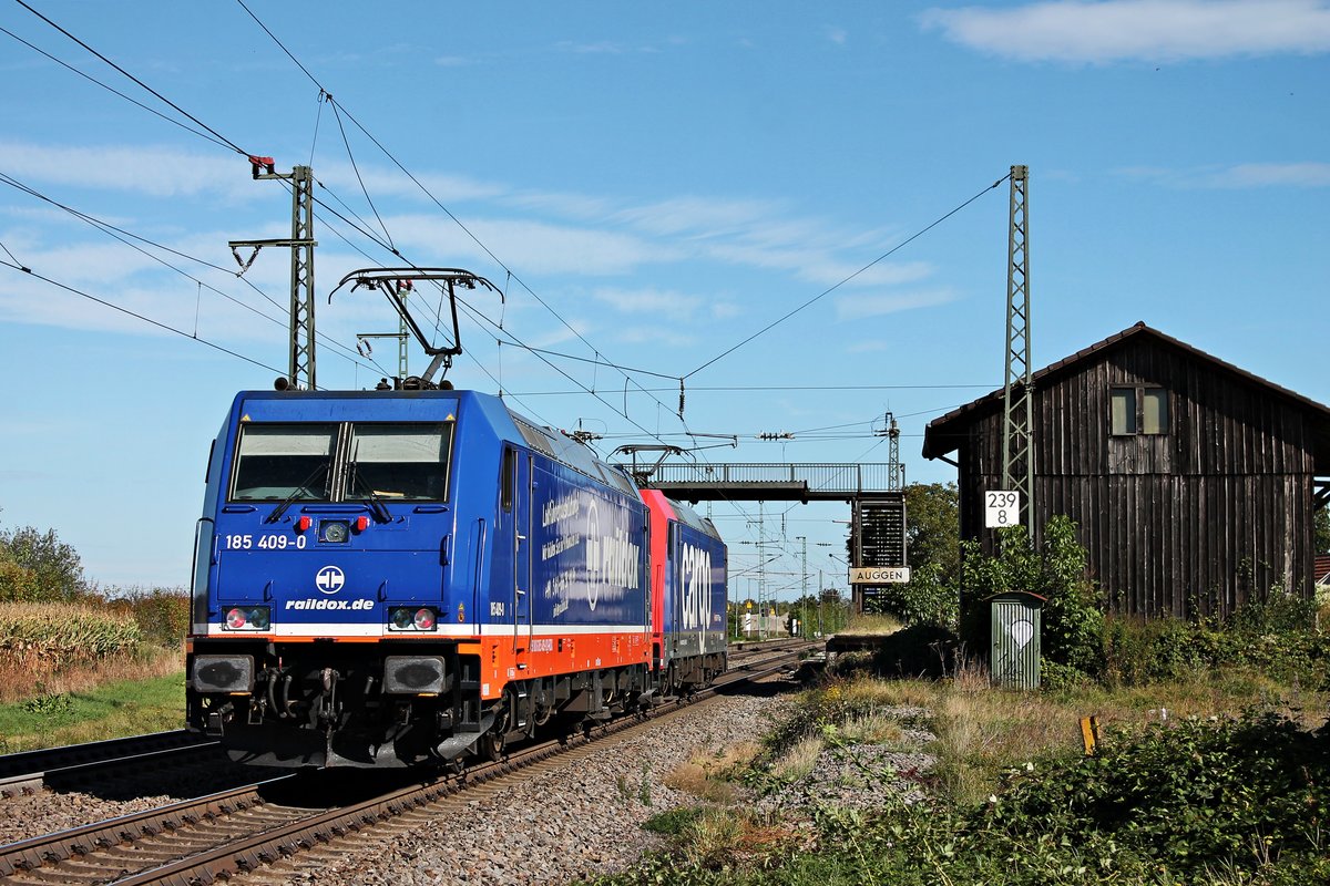 Nachschuss auf 185 409-0, als diese am Vormittag des 29.09.2019 zusammen mit SBBC/RDX Re 482 035-3 als Lokzug aus Basel Bad Bf durch den Haltepunkt von Auggen in Richtung Müllheim (Baden) fuhren. Zuvor brachten sie einen vollen  Rüben -Zug aus Ostdeutschland in die Schweiz.