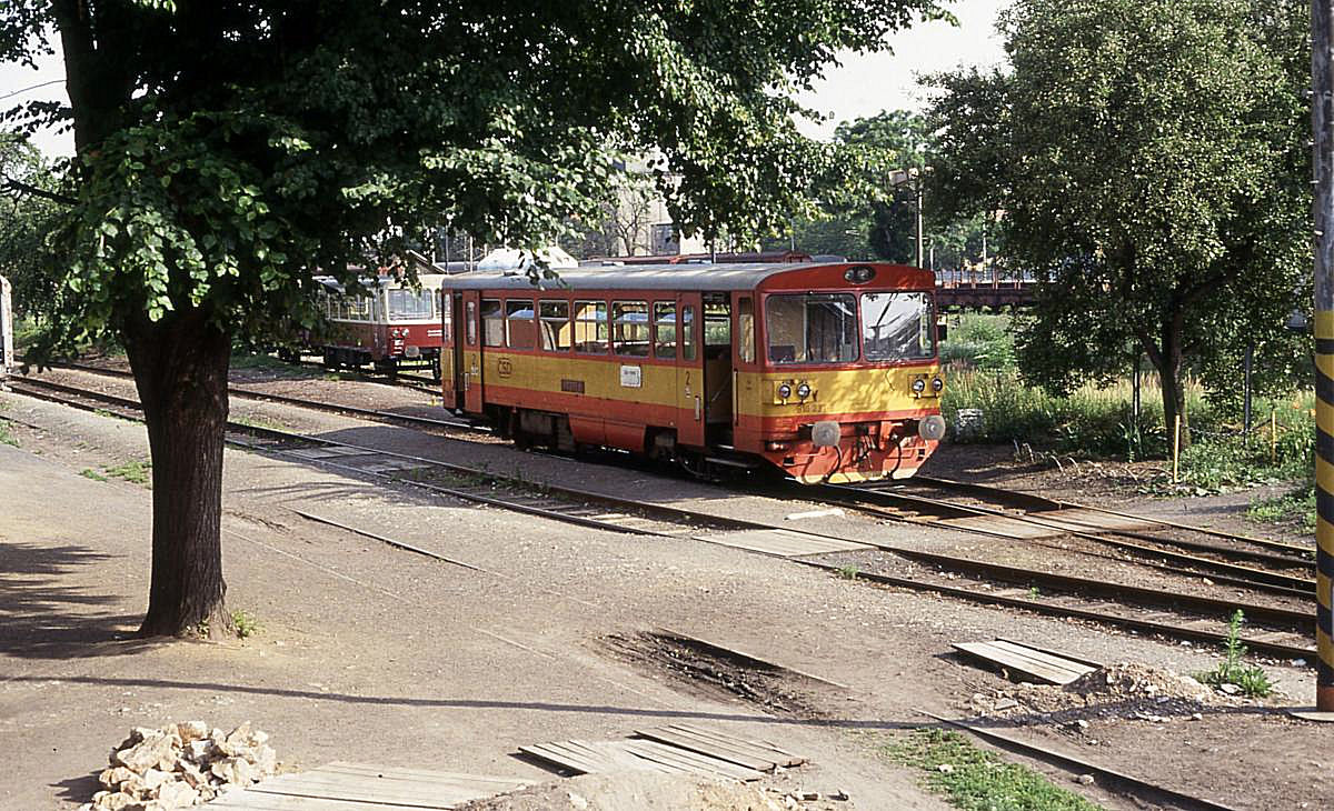 Nebenbahn Atmosphäre in Caslav Ost am 28.6.1992. Triebwagen 810237 steht im Schatten der Bäume am Bahnsteig und wartet auf die nächste Einsatzfahrt nach Tremosnice. Der kleine Bahnhof Caslav Ost ist vom Hauptbahnhof nur durch die Gleise der Hauptbahn getrennt und ist von dort aus über eine Fußgängerbrücke erreichbar.