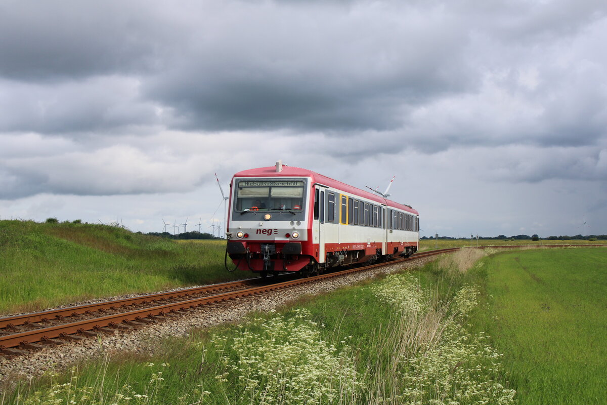 neg 628 071-2 fährt auf der Kleinbahn von Niebüll nach Dagebüll Mole und hat hier soeben den Haltepunkt Maasbüll verlassen. (30.05.2022)