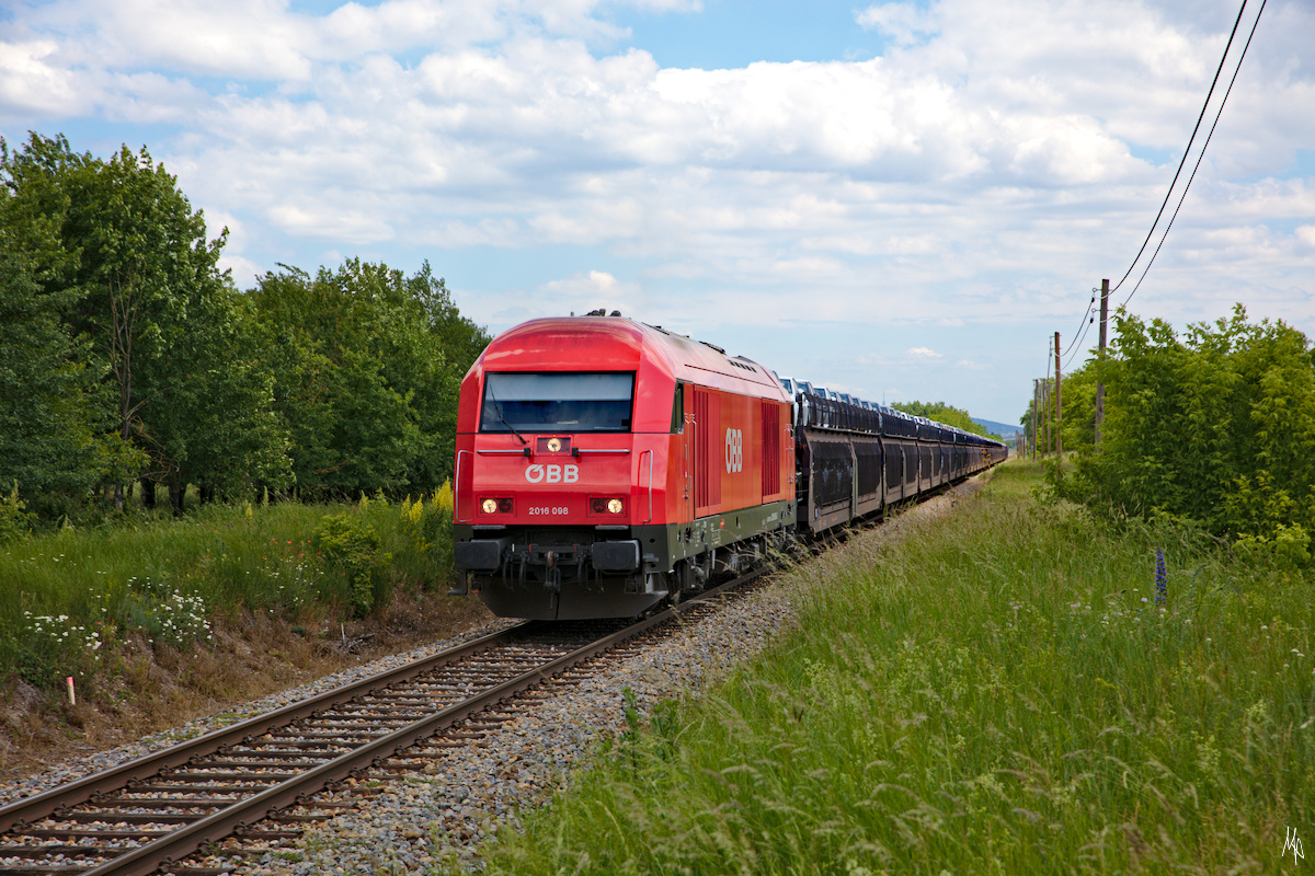 Noch einmal die Betriebsausweiche Salmhof mit der 2016.098, die einen Ganzzug mit Neuwagen, die aus einem Automobilwerk nahe Bratislava stammen, am Haken hat. Während ich auf den Zug gewartete hatte, stand ich im schönsten Sonnenlicht, doch als der Zug kam, kam auch eine Fotowolke. 