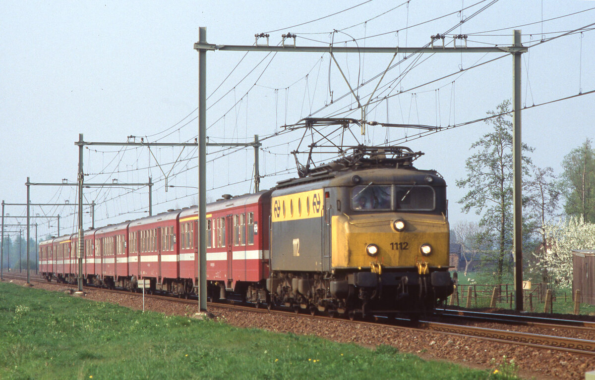 NS 1112 mit IC-4663 (Zwolle - Vlissingen) bei Elst am 15.04.1991, 17.31u. Die Wagen sind  vom Typ M2 der NMBS. Scan (Bild 98832, Kodak Ektachrome100HC). 