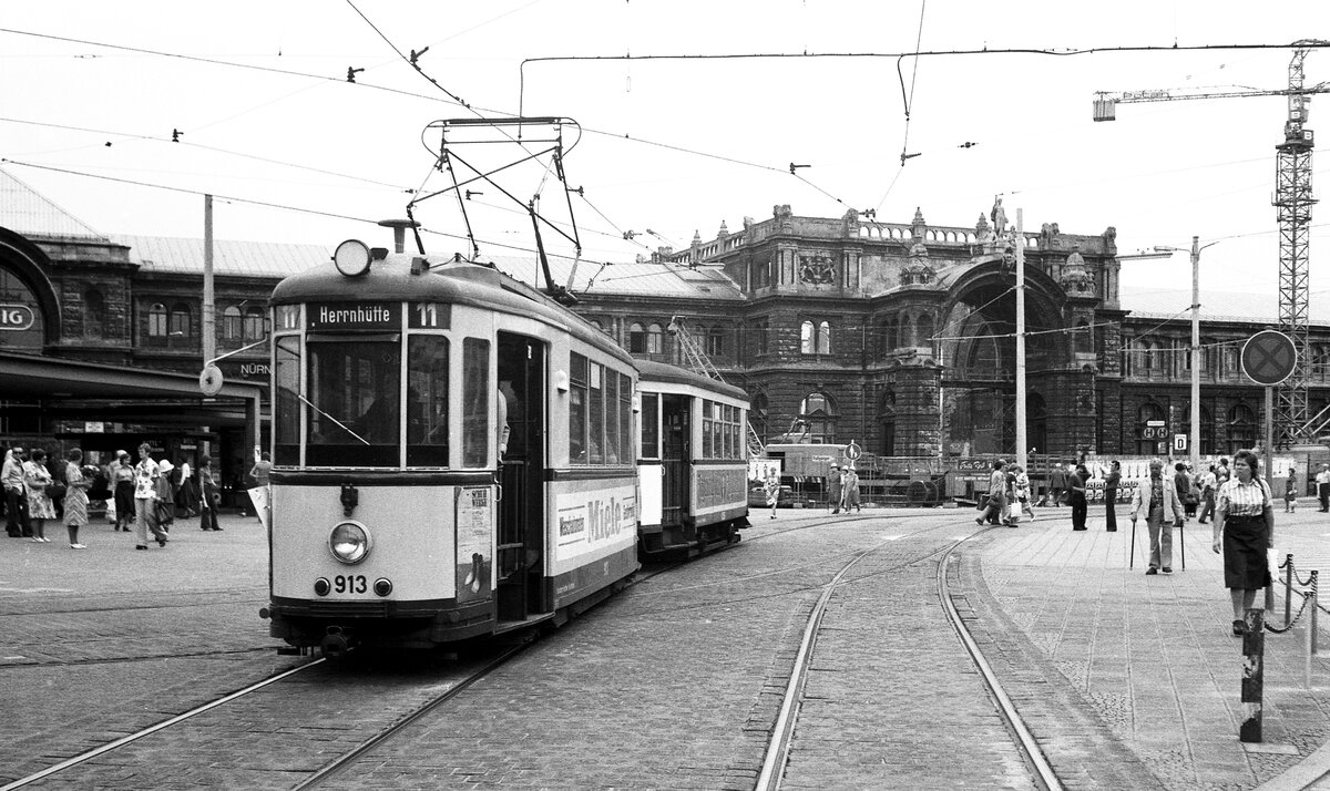 Nürnberg-Fürther Straßenbahn__Tw 913 [DUEWAG/SSW 1940] mit Bw 1256 [MAN 1951] auf Linie 11 nach 'Herrnhütte' im NO von Nürnberg. Im Hintergrund sieht man nicht den Nürnberger Hbf. im Zustand von 1945, sondern im Zustand des U-Bahnbaus der 70er Jahre.__21-07-1976