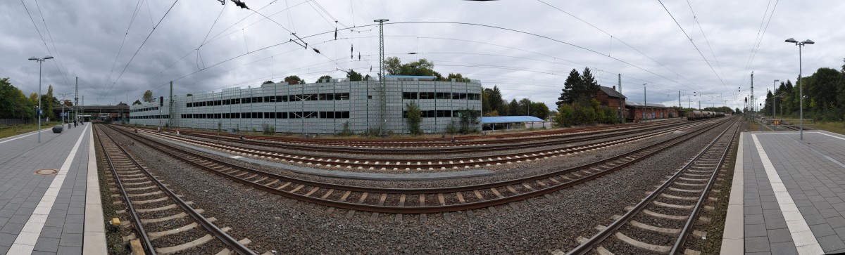 Panorama-Bild 3/3 des Bahnhofes  Stade  am Gleis 2. Fast am Ende des Bahnsteiges steht gegenüber das Parkhaus und rechts daneben der alte, nicht mehr genutzte, Güterschuppen, der leider vor sich hinwittert. 