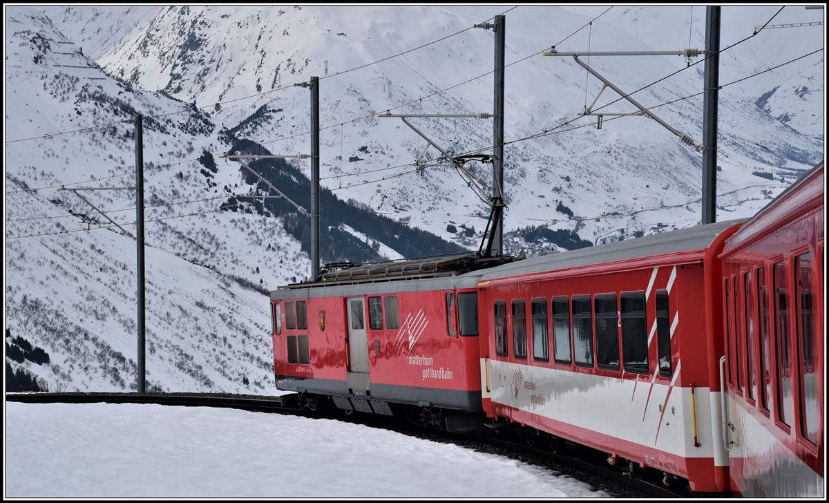 R823 mit Deh 4/4 21 ist oberhalb Andermatt auf der Talfahrt vom Oberalppass. (10.04.2019)