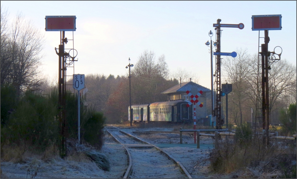 Rauhreif, Schattenspiele und ein angenehmes Streiflicht der tiefstehenden Sonne veranlassten mich zu dieser Aufnahme auf dem Gelände der Vennbahn in Raeren (Belgien), am 20.Dez.2016. 
Der Blick schweift auf die Ausfahrt in Richtung Eupen, vorbei an den Signalen und den abgestellten Hechtwagen im Hintergrund. Dort steht auf das Stellwerk (Cab ||).
Das Gelände und die Bahnanlage sind frei zugänglich und laden immer wieder zum Verweilen ein.