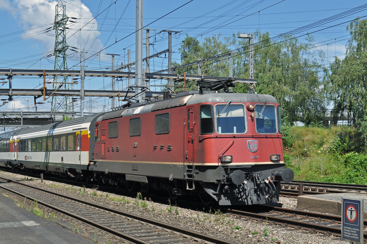 Re 4/4 II 11200 durchfährt den Bahnhof Muttenz. Die Aufnahme stammt vom 01.08.2016.