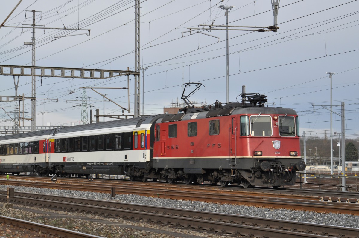 Re 4/4 II 11300 durchfährt den Bahnhof Muttenz. Die Aufnahme stammt vom 31.01.2015.