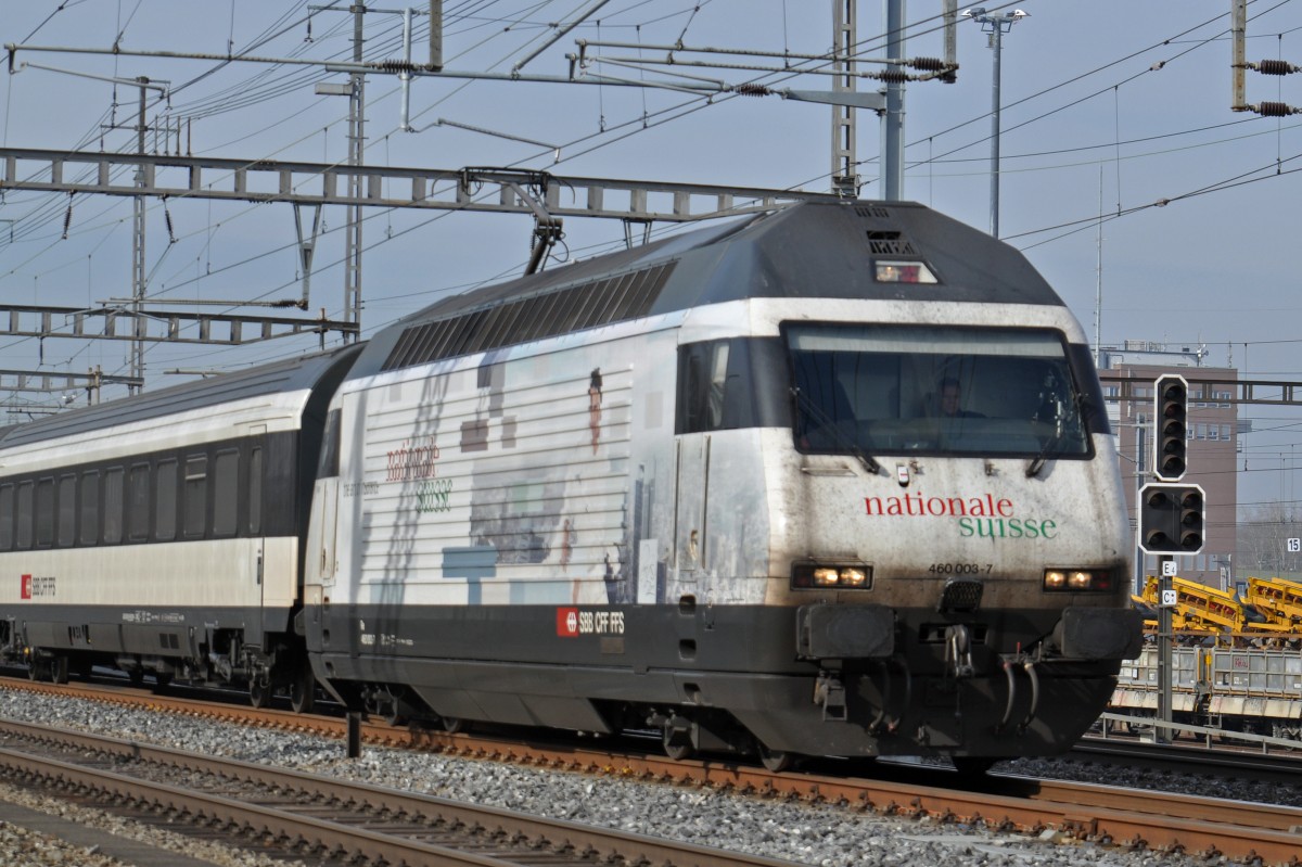 Re 460 003-7 mit der NATIONAL SUISSE Werbung durchfährt den Bahnhof Muttenz. Die Aufnahme stammt vom 13.02.2015.