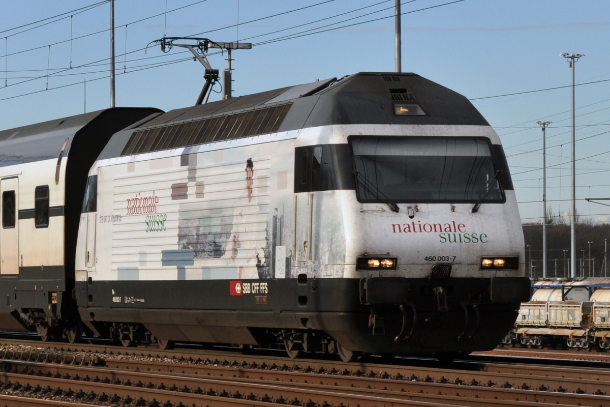 Re 460 003-7 mit der nationale suisse Werbung durchfährt den Bahnhof Muttenz. Die Aufnahme stammt vom 17.01.2014.