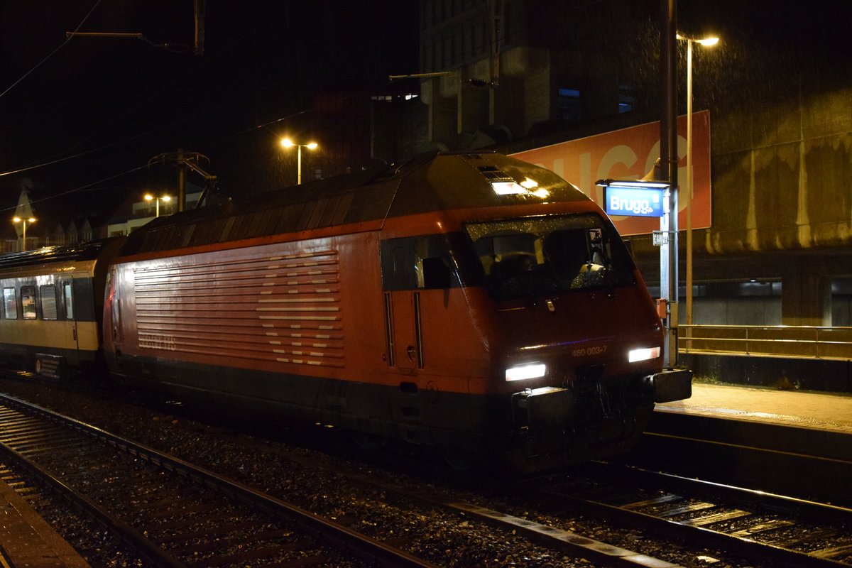Re 460 003-7 wartet am Abend des 28.11.2017 in Brugg bei strömenden Regen auf den Abfahrtsbefehl des Zugschefs.