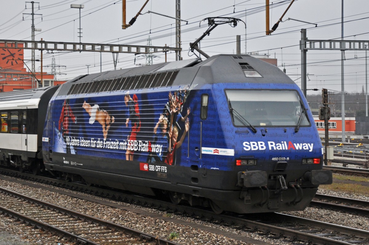 Re 460 050-8 mit der SBB Rail a Way Werbung durchfährt den Bahnhof Muttenz. Die Aufnahme stammt vom 13.01.2014.