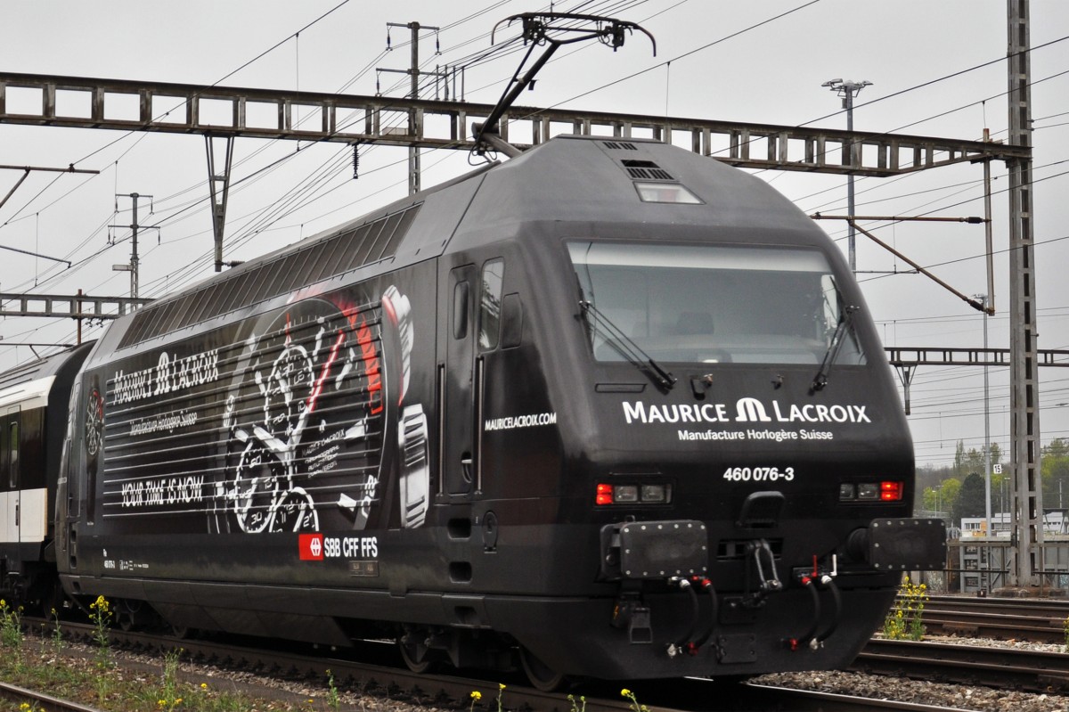 Re 460 076-3 mit der Maurice Lacriox Werbung durchfährt den Bahnhof Muttenz.