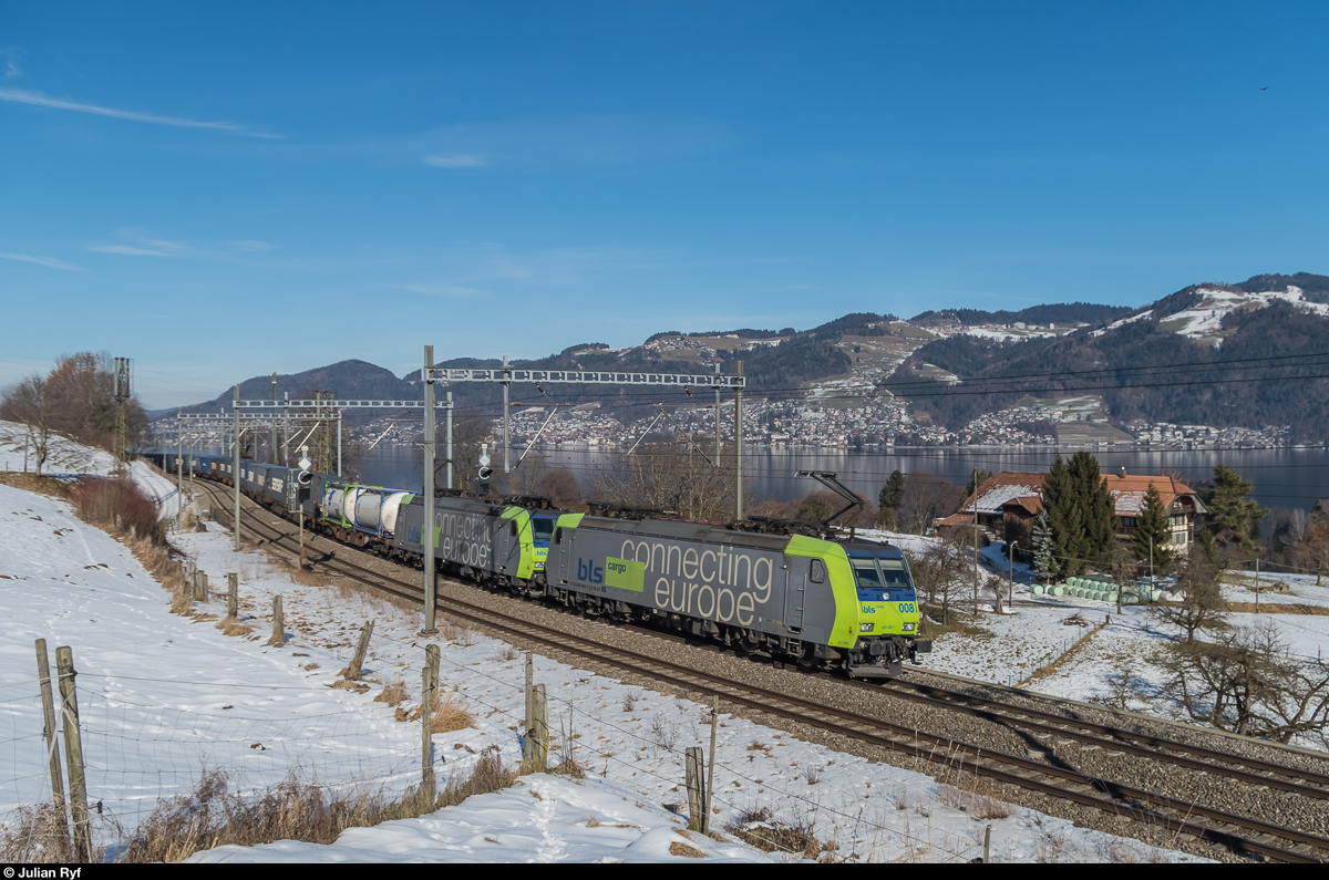 Re 485 008 durchfährt am 29. Januar 2017 mit einer Schwesterlok vor einem UKV-Zug die ehemalige Haltestelle Kumm am Thunersee.
