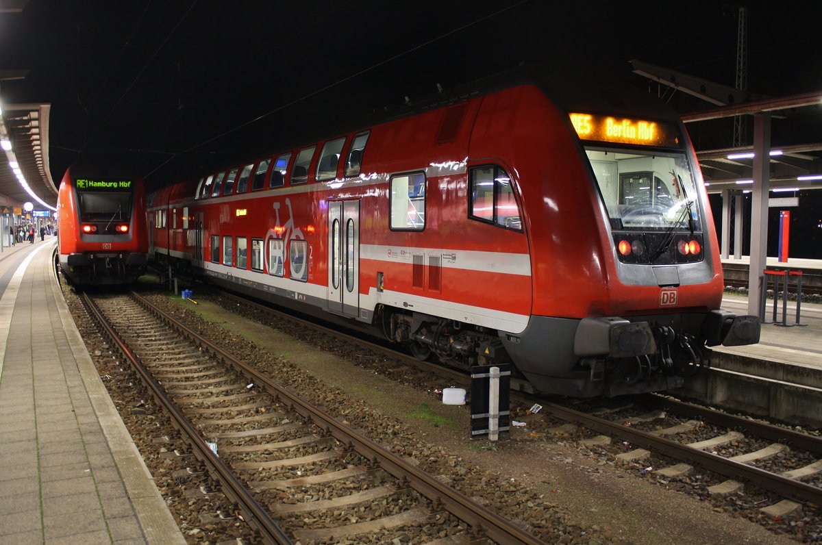 RE5 (RE18491)  Warnemünde-Express  von Warnemünde nach Berlin Hauptbahnhof (tief) trifft am Abend des 03.11.2018 im Rostocker Hauptbahnhof auf den RE1 (RE4316)  Hanse-Express  nach Hamburg Hauptbahnhof. 