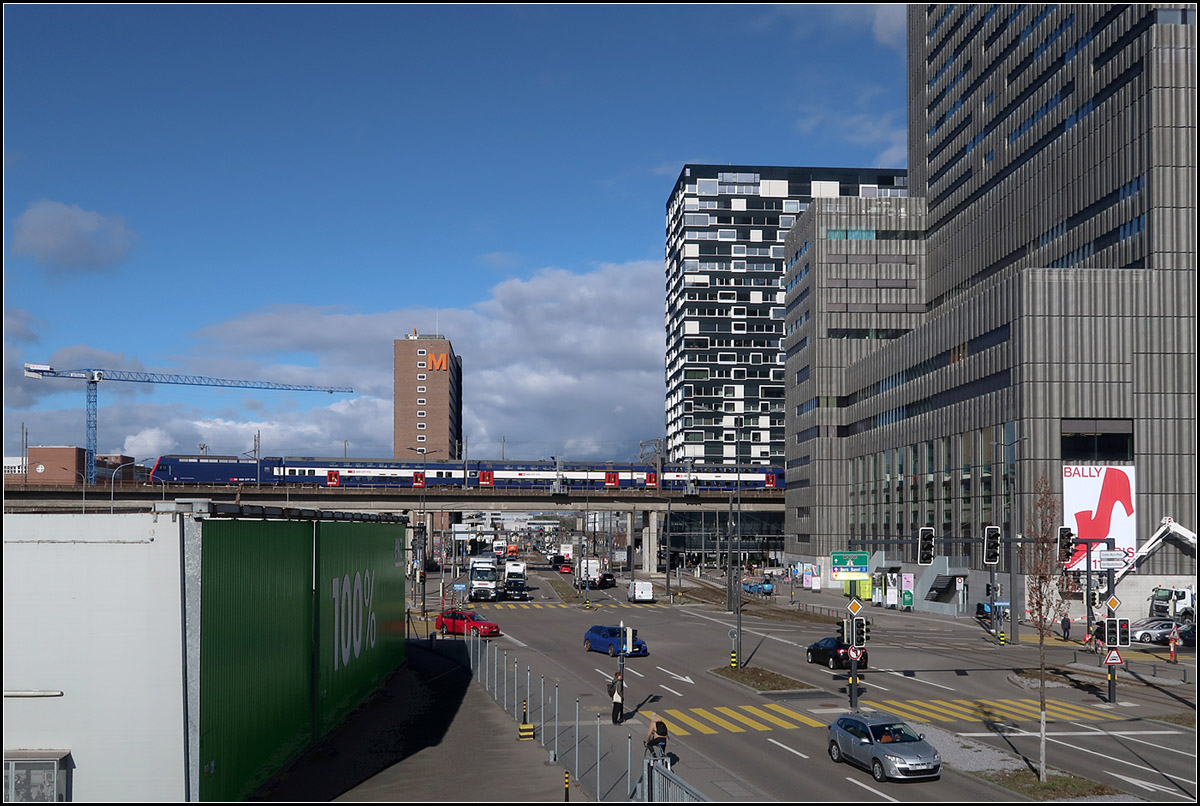 Recht unscheinbar zwischen den gewaltigen Bauten -

... auch aufgrund seiner Farbgebung ist dieser S-Bahnzug auf der Viaduktstrecke im Züricher Limmattal unterwegs.

13.03.2019 (M)

