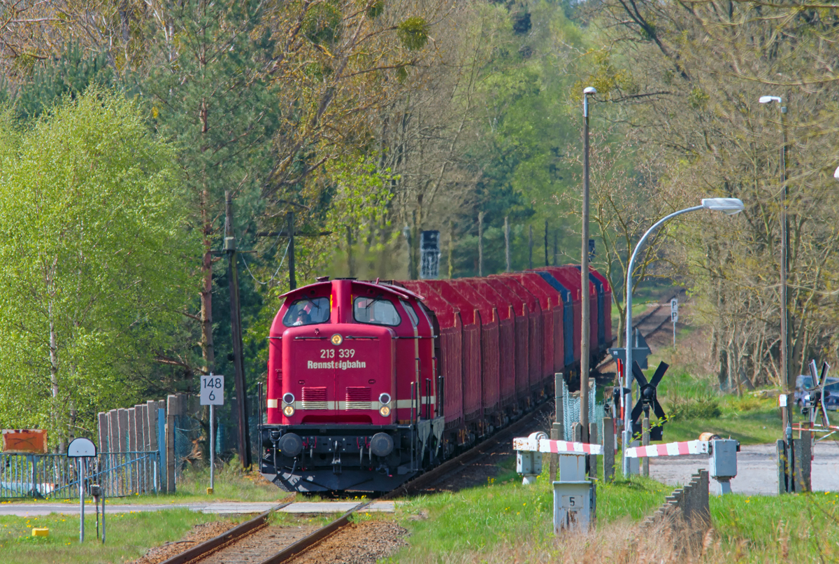 Rennsteigbahn mit Wagen zur Holzverladung ist im Torgelower Bahnhof eingefahren und befindet sich gerade am BÜ mit elektrischer Vollschranke im Km 148,6. - 29.04.2015
