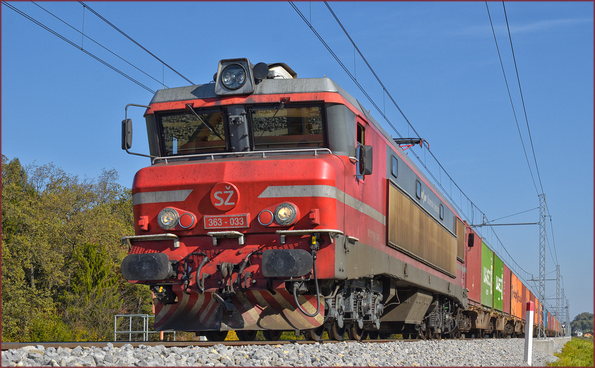 SŽ 363-033 zieht Containerzug an Črešnjevec vorbei Richtung Koper Hafen. /20.10.2017