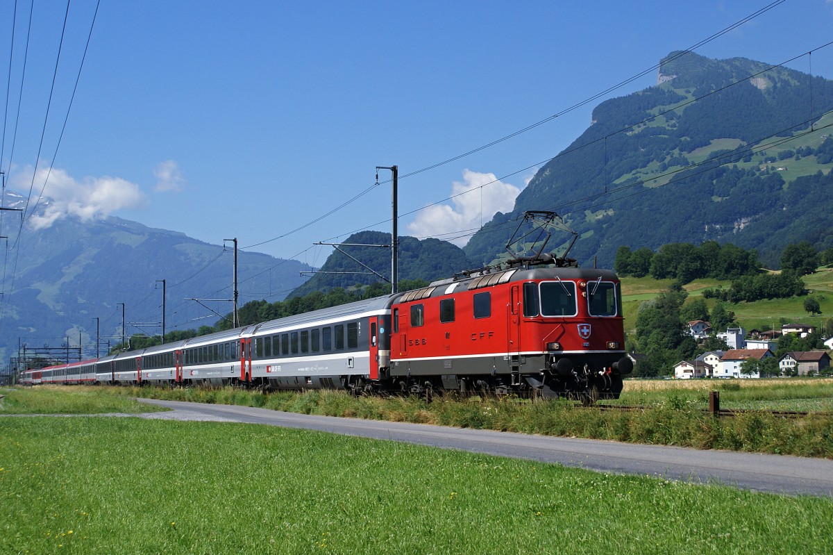 SBB: Re 4/4 11121 mit EC Zürich - Buchs zwischen Sargans und Buchs im Juni 2008. Die mitgeführten Wagen stammen von der Schweizerischen- und der Oesterreichischen Bundesbahn. 
Foto: Walter Ruetsch