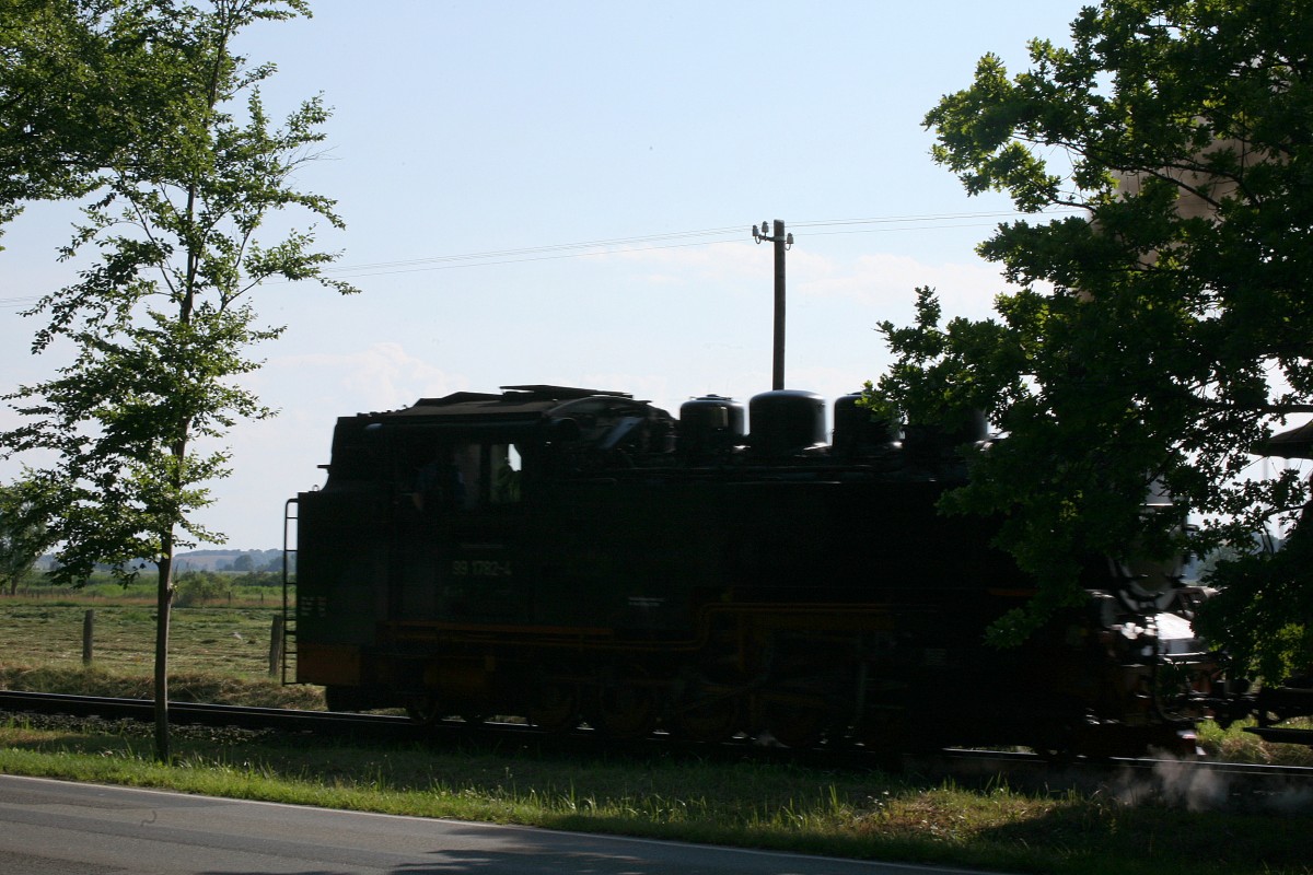 Schade, die Autofahrer nehmem auf Bahnfotogerafen keine Rücksicht, es sollte der vollständige Schatten der Lok abgebildet werden, aber es kam immer eiun Auto dazwischen  , Ablehnung ?  Zug der RÜBB von Sellin auf dem Wege nach Baabe. 15.07.2014  17:12 Uhr.