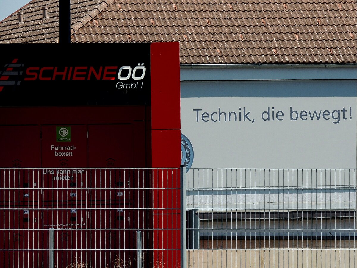 Schiene-OÖ, Technik die bewegt!, oder doch nur hinter Gitter befindliche eingeschlossene mietbare Fahrradboxen? so gesehen im Bereich des Bhf. Ried i.I.; 220725