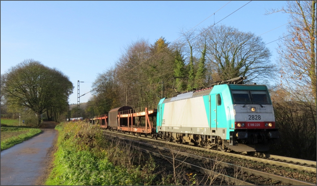 Schönes Spätherbstwetter lockte mich am 27.11.15 mal wieder zu einen Spaziergang entlang der Montzenroute unweit von Aachen. Gerade kommt die Cobra 2828 mit ihrer Fuhre aus Belgien die Gemmenicher Rampe hinunter.  