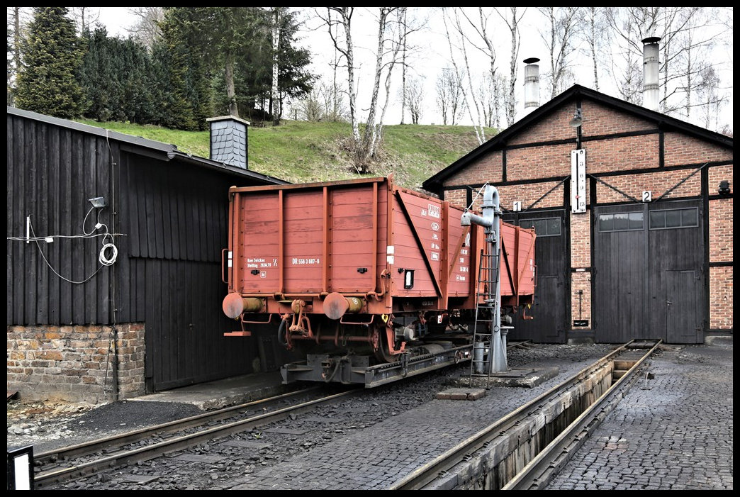 Sonntagsruhe am 16.4.2023 in Jöhstadt. Vor dem Schuppentor stand ein Rollwagen mit einem darauf befindlichen ehemaligen DR offenen Güterwagen.   