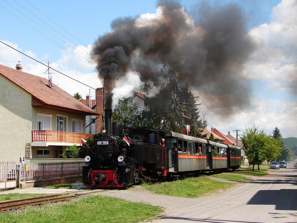 Steam in the street! :) Morgó von Királyrét Waldbahn (Schmalspurbahn in Ungarn)auf dem Weg von Kismaros nach Királyrét. Morgo war in Resita - Rumänien gebaut in 1951.
Die Strecke läuft durch die Straßen in Szokolya.
490 2004  Morgó   Szokolya 08.05.2016.