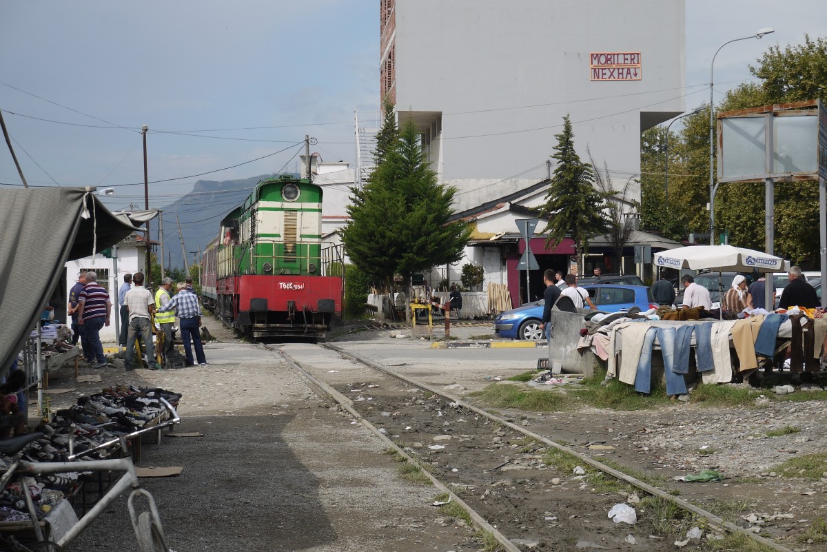 T 669.1054 quert mit ihrem 2-Wagen-Zug nach Librazhd den sogenannten  Freien Markt  in Elbasan (7.9.14).
