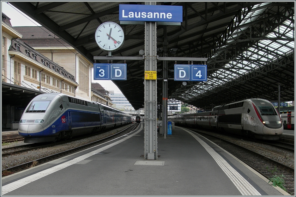 TGV Bahnhof Lausanne: Während rechts im Bild der TGV Lyria auf seine Abfahrtszeit nach Paris um 12.24 wartet, steht (ohne dass ich den Grund dafür kenne) auf Gleis zwei ein SNCF Doppelstock TGV. 
24. Juni 2014
