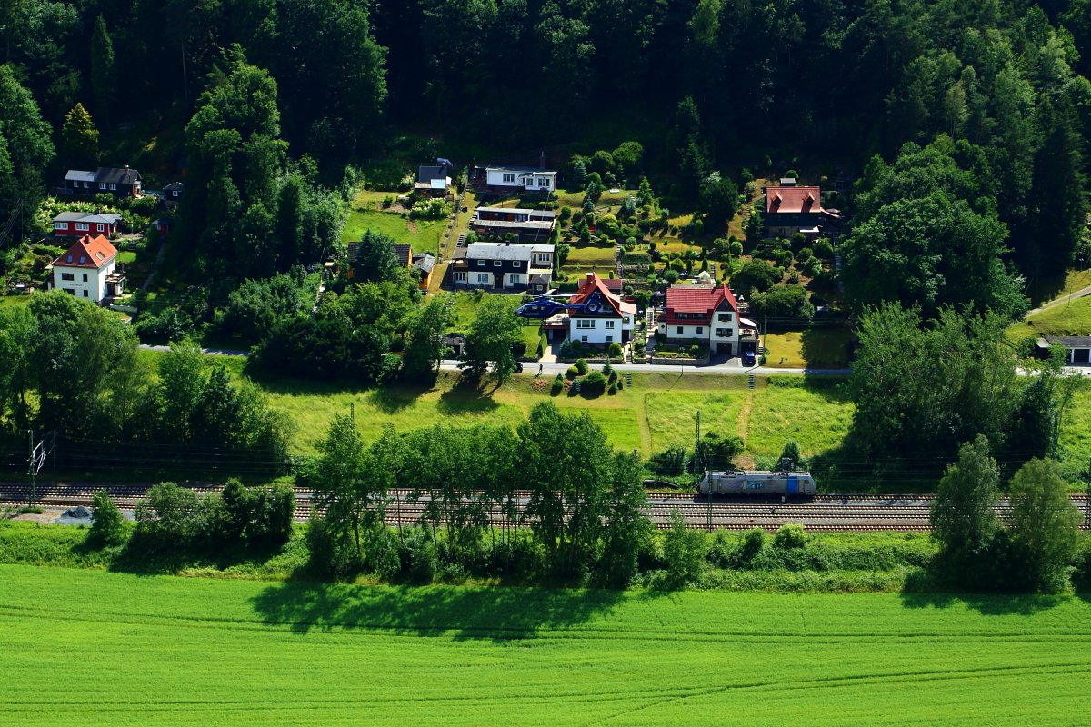 Treffen Luft und Schiene. Ein Hubschrauber folgt am 16.06.2017 der Elbtalstrecke und überfliegt dabei eine am Signal wartende E-Lok. Der Schnappschuß erfolgte vom Basteifelsen aus.