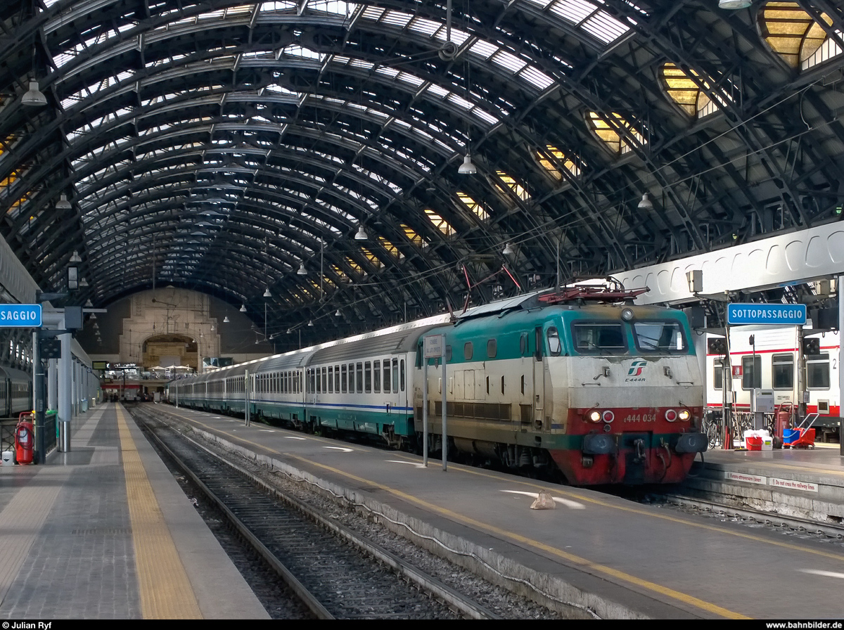 Trenitalia E.444 034 wartet am 3. Mai 2014 in der wunderschönen Bahnhofshalle vom Bahnhof Milano Centrale vor dem IC nach Genova - Ventimiglia auf die Abfahrt.